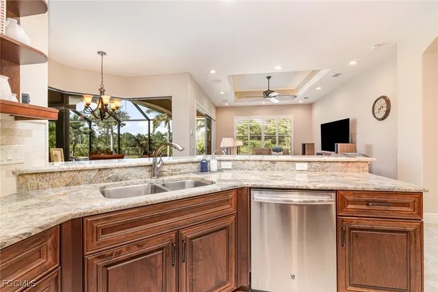 a kitchen with stainless steel appliances granite countertop a sink and a stove