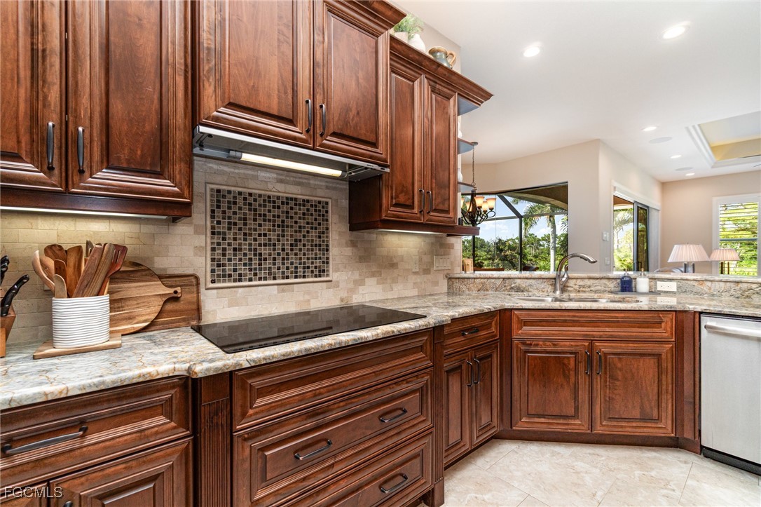 6135 Calusa Rdg Trail Bokeelia, FL 33922 - Photo 9 of 46 a kitchen with granite countertop stainless steel appliances a sink and cabinets