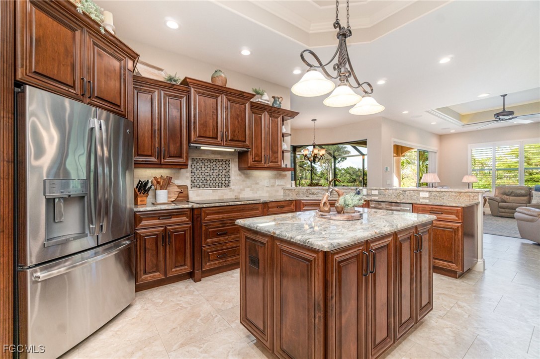6135 Calusa Rdg Trail Bokeelia, FL 33922 - Photo 10 of 46 a kitchen with stainless steel appliances granite countertop a stove refrigerator and cabinets