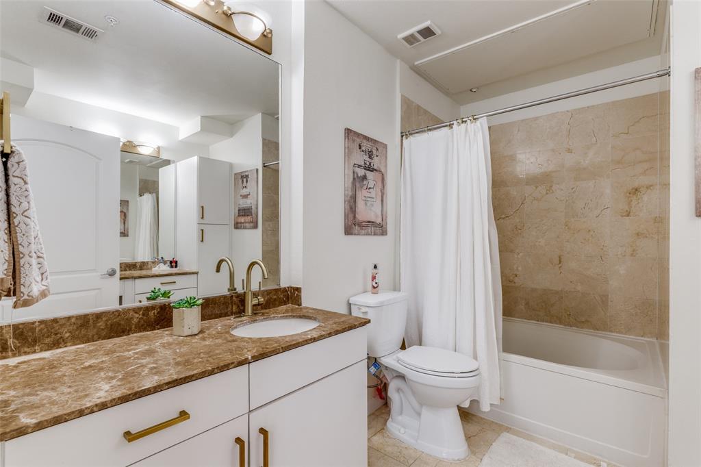 3225 Turtle Creek, Unit 719 Dallas, TX 75219 - Photo 11 of 24 a bathroom with a granite countertop sink toilet and shower