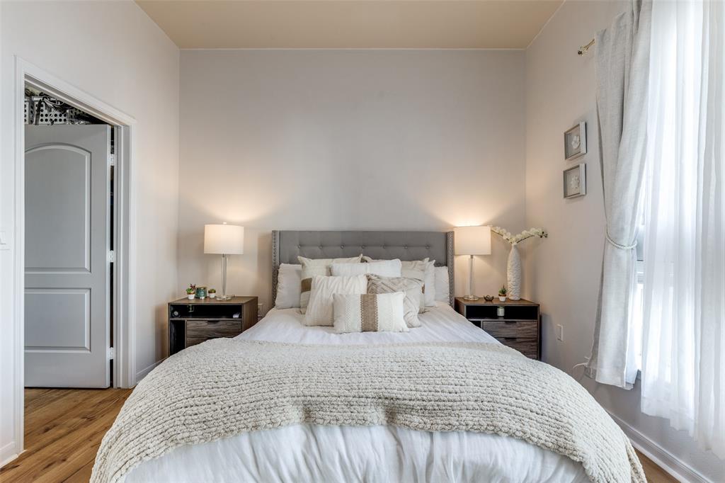 3225 Turtle Creek, Unit 719 Dallas, TX 75219 - Photo 13 of 24 a bedroom with a bed and wooden floor
