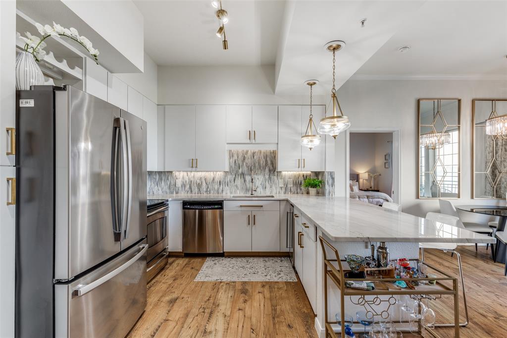 3225 Turtle Creek, Unit 719 Dallas, TX 75219 - Photo 6 of 24 a kitchen with stainless steel appliances granite countertop a refrigerator and a stove