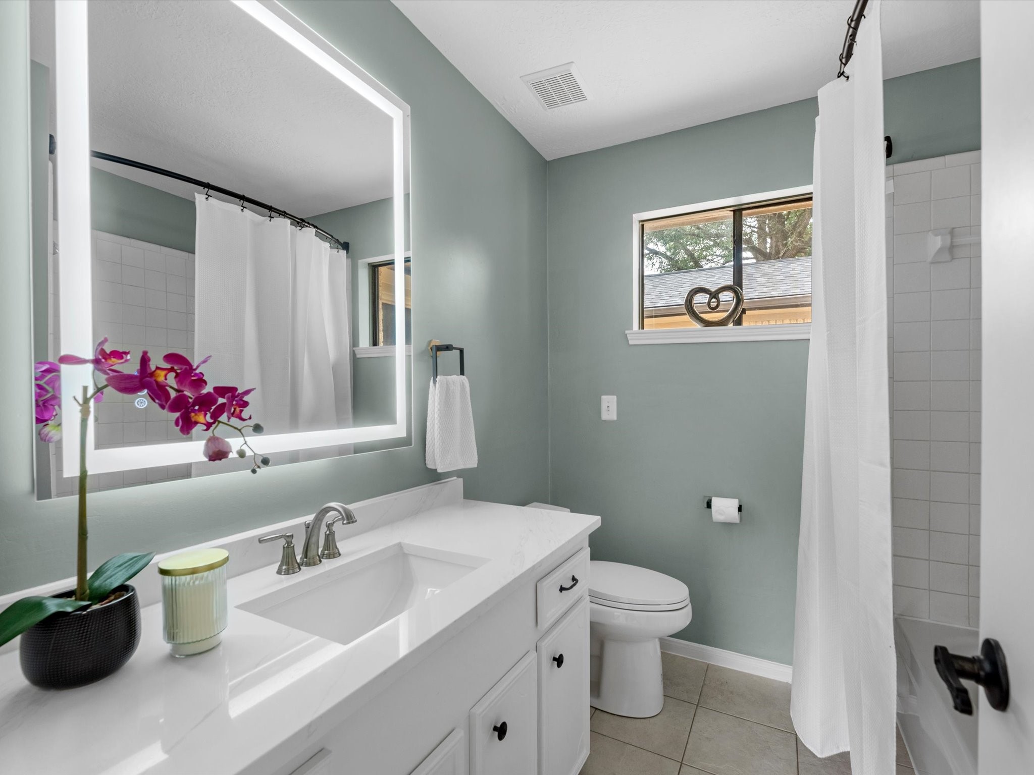 4002 Cujanes Street Pasadena, TX 77504 - Photo 21 of 26 a bathroom with a toilet sink and mirror