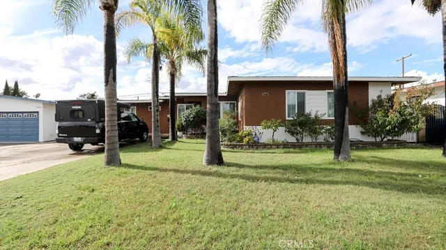 a view of a house with a yard and porch