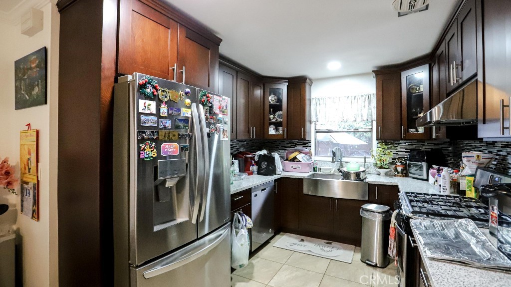 11821 Easy Way Garden Grove, CA 92840 - Photo 14 of 48 a kitchen with stainless steel appliances granite countertop a refrigerator and a sink