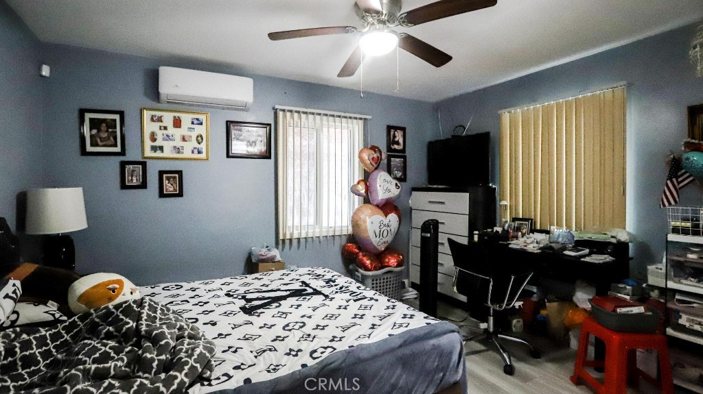 11821 Easy Way Garden Grove, CA 92840 - Photo 17 of 48 a bedroom with a bed and wooden floor