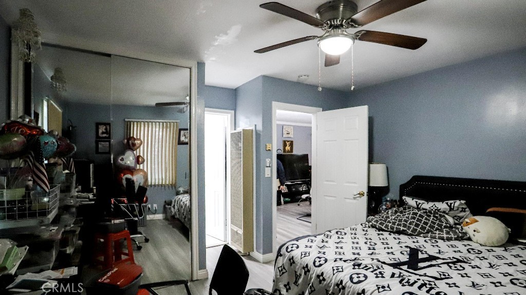 11821 Easy Way Garden Grove, CA 92840 - Photo 18 of 48 a bedroom with a bed and a chandelier