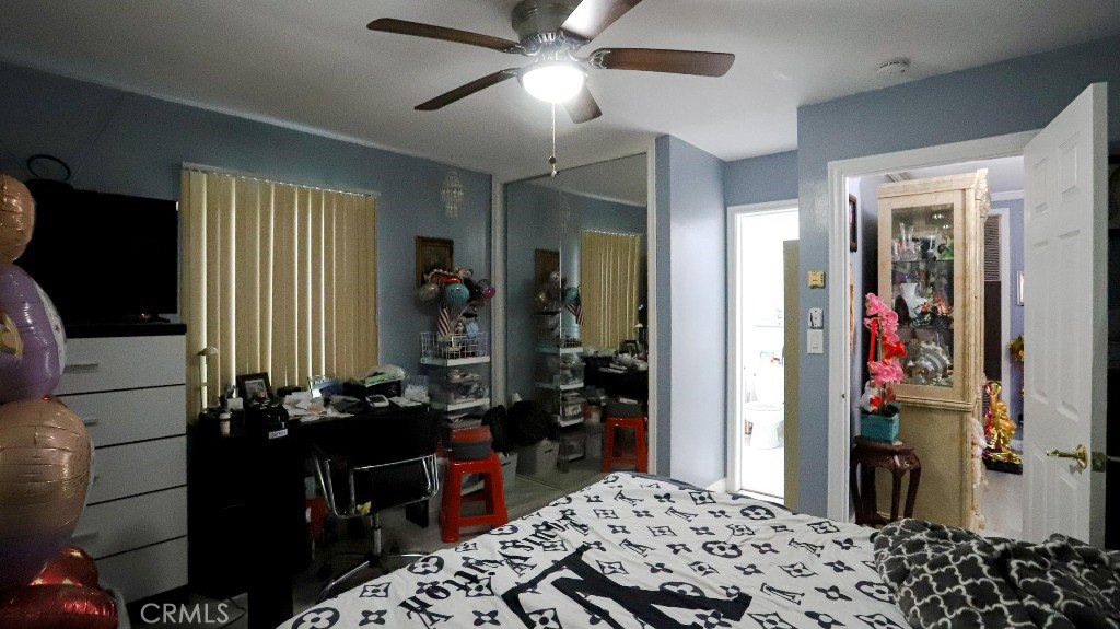 11821 Easy Way Garden Grove, CA 92840 - Photo 19 of 48 a bedroom with a bed and a chandelier