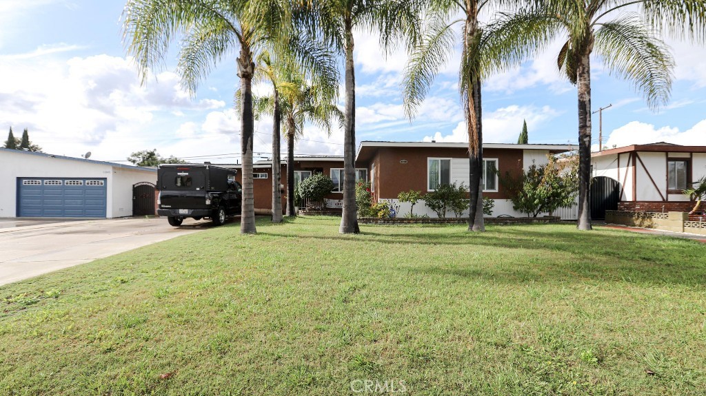 11821 Easy Way Garden Grove, CA 92840 - Photo 2 of 48 a house with palm tree in front of it