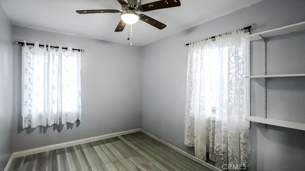 11821 Easy Way Garden Grove, CA 92840 - Photo 25 of 48 a view of an empty room with wooden floor and a window