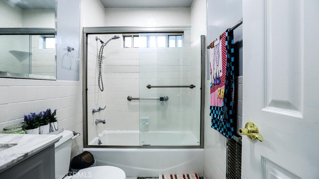 11821 Easy Way Garden Grove, CA 92840 - Photo 28 of 48 a bathroom with a shower curtain and a potted plant