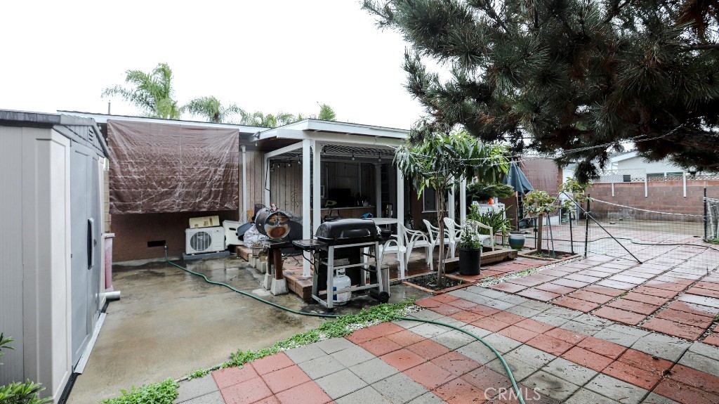 11821 Easy Way Garden Grove, CA 92840 - Photo 35 of 48 a view of a dinning tables and chairs in backyard of the house