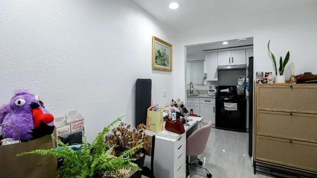 a kitchen with a refrigerator and a stove
