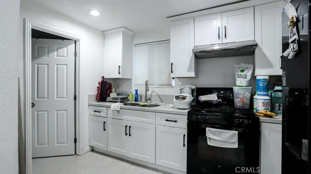 a kitchen with cabinets and appliances