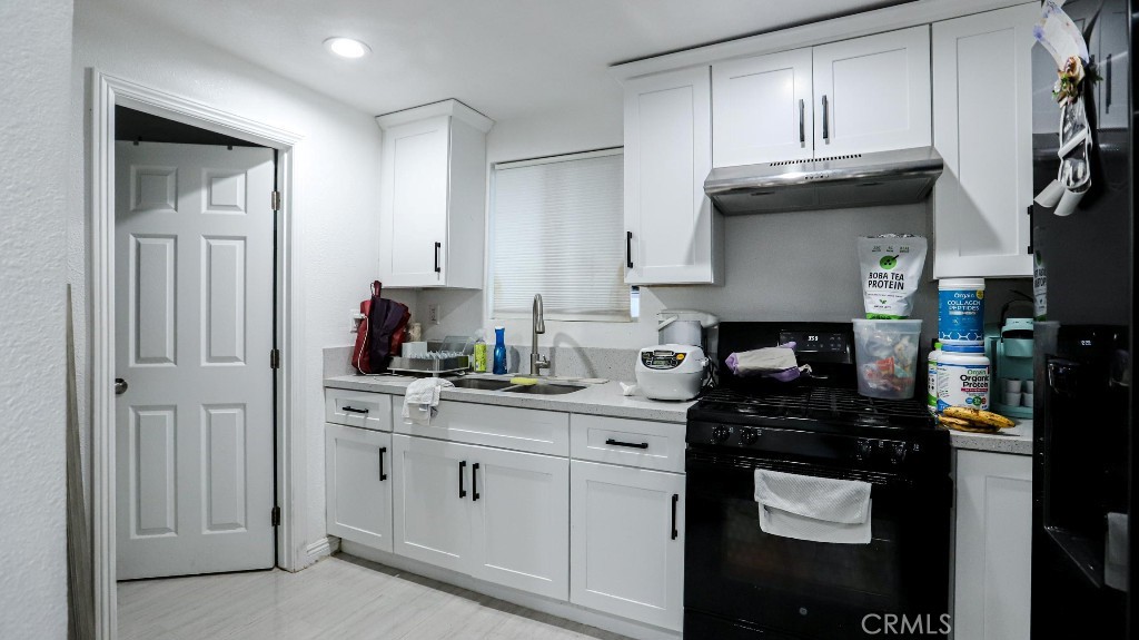 11821 Easy Way Garden Grove, CA 92840 - Photo 42 of 48 a kitchen with cabinets and appliances