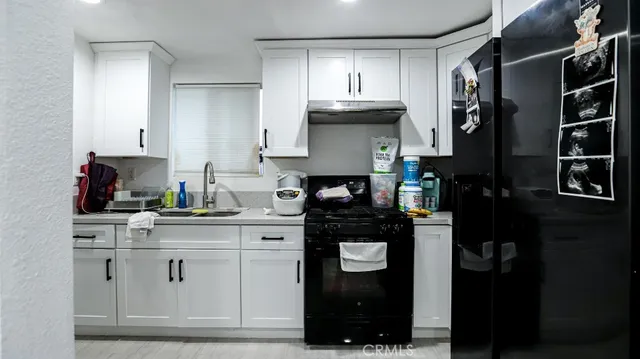 a kitchen with a refrigerator and cabinets