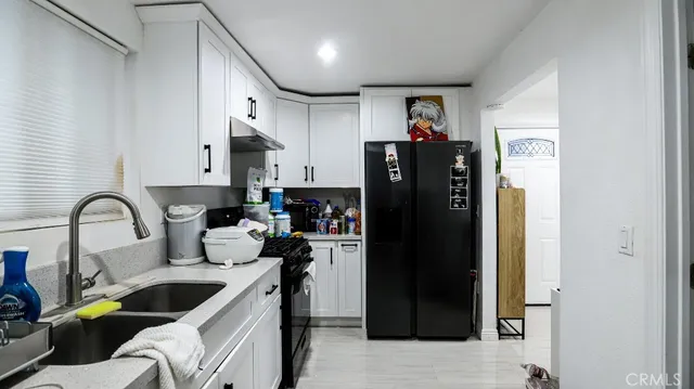 a view of living room with furniture and refrigerator