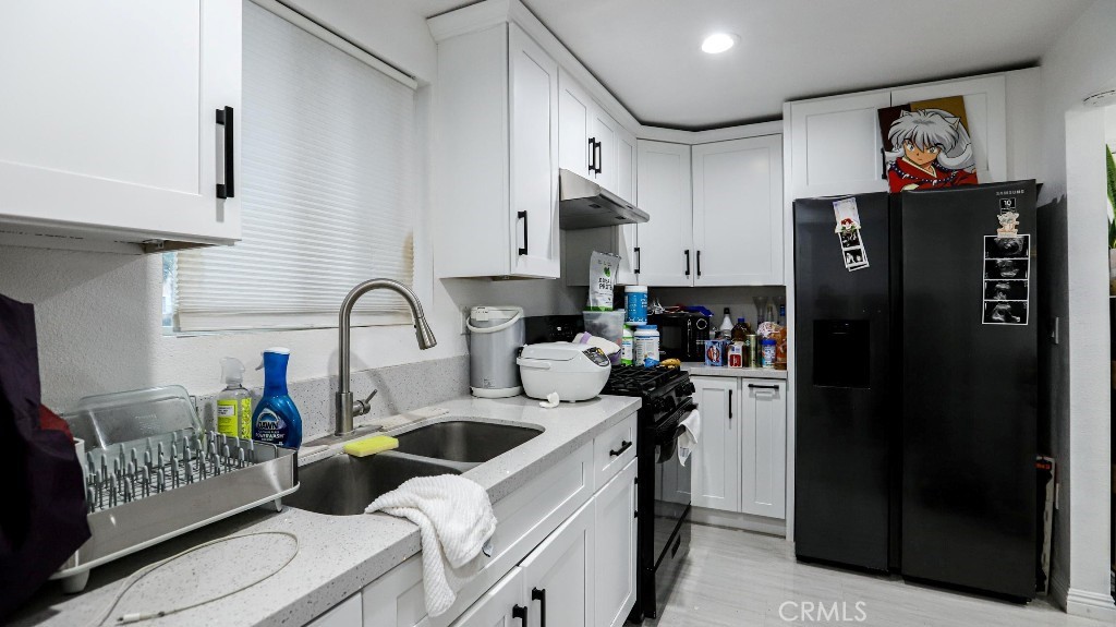 11821 Easy Way Garden Grove, CA 92840 - Photo 45 of 48 a kitchen with stainless steel appliances granite countertop a refrigerator and a sink