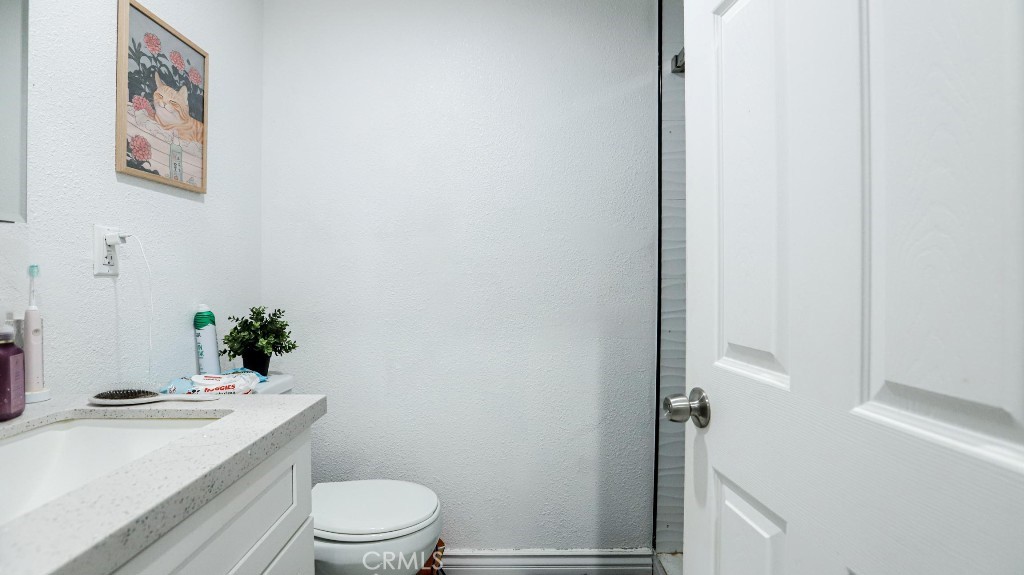 11821 Easy Way Garden Grove, CA 92840 - Photo 48 of 48 a bathroom with a sink a toilet and shower