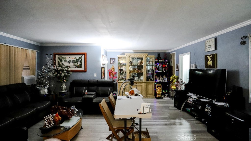 11821 Easy Way Garden Grove, CA 92840 - Photo 7 of 48 a living room with furniture and a flat screen tv