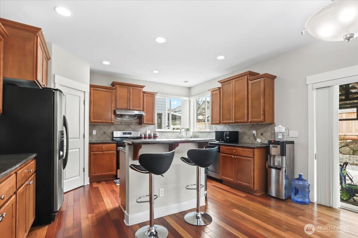 901 Jericho Place Northeast Renton, WA 98059 - Photo 13 of 38 a kitchen with granite countertop appliances cabinets and wooden floor