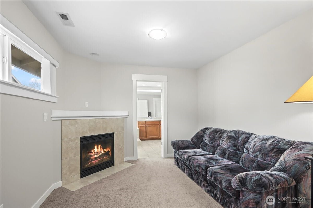 901 Jericho Place Northeast Renton, WA 98059 - Photo 27 of 38 a living room with furniture and a fireplace