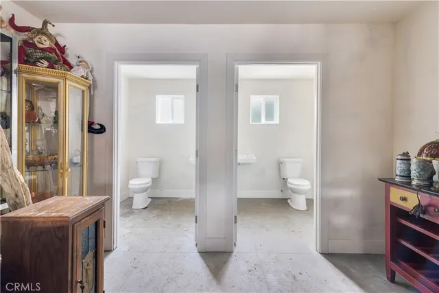a view of bathroom with a toilet sink and mirror