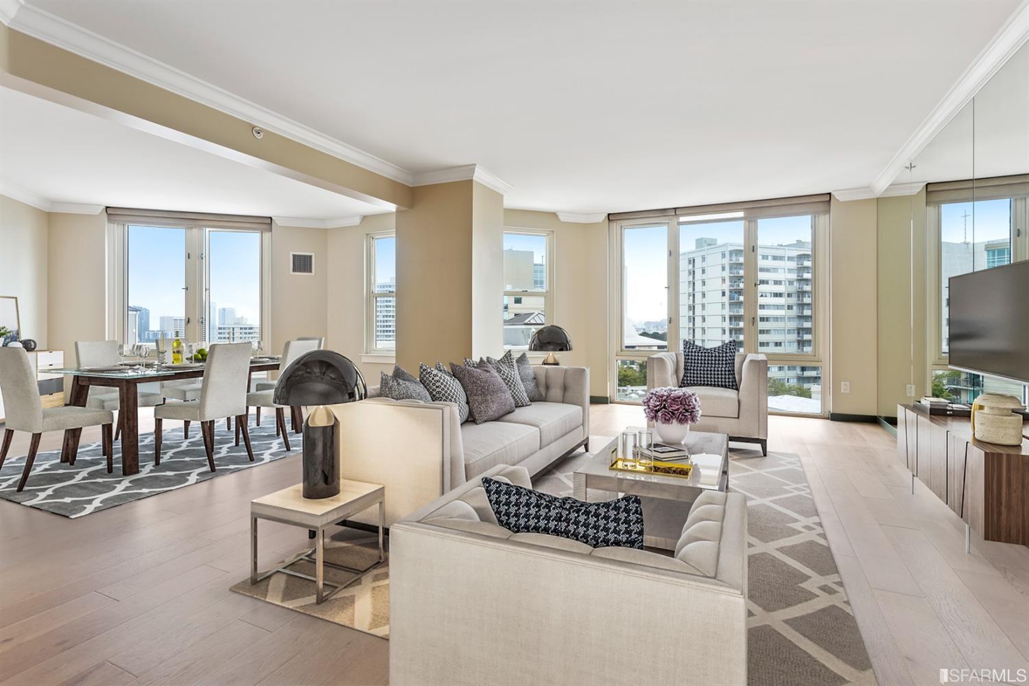 a living room with furniture a large window and a flat screen tv