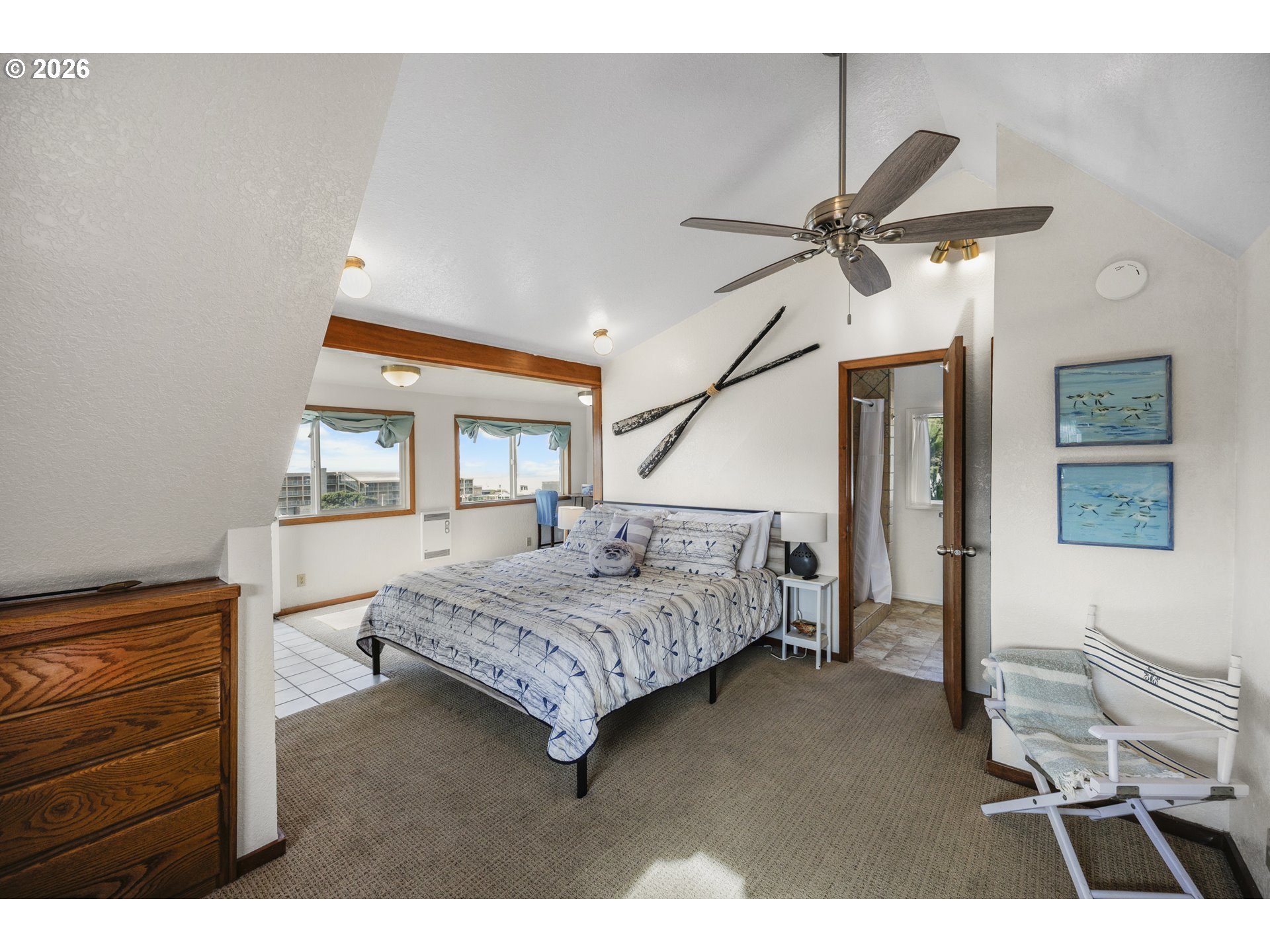 88426 2nd Avenue Florence, OR 97439 - Photo 12 of 45 a bedroom with a bed a dresser and potted plants