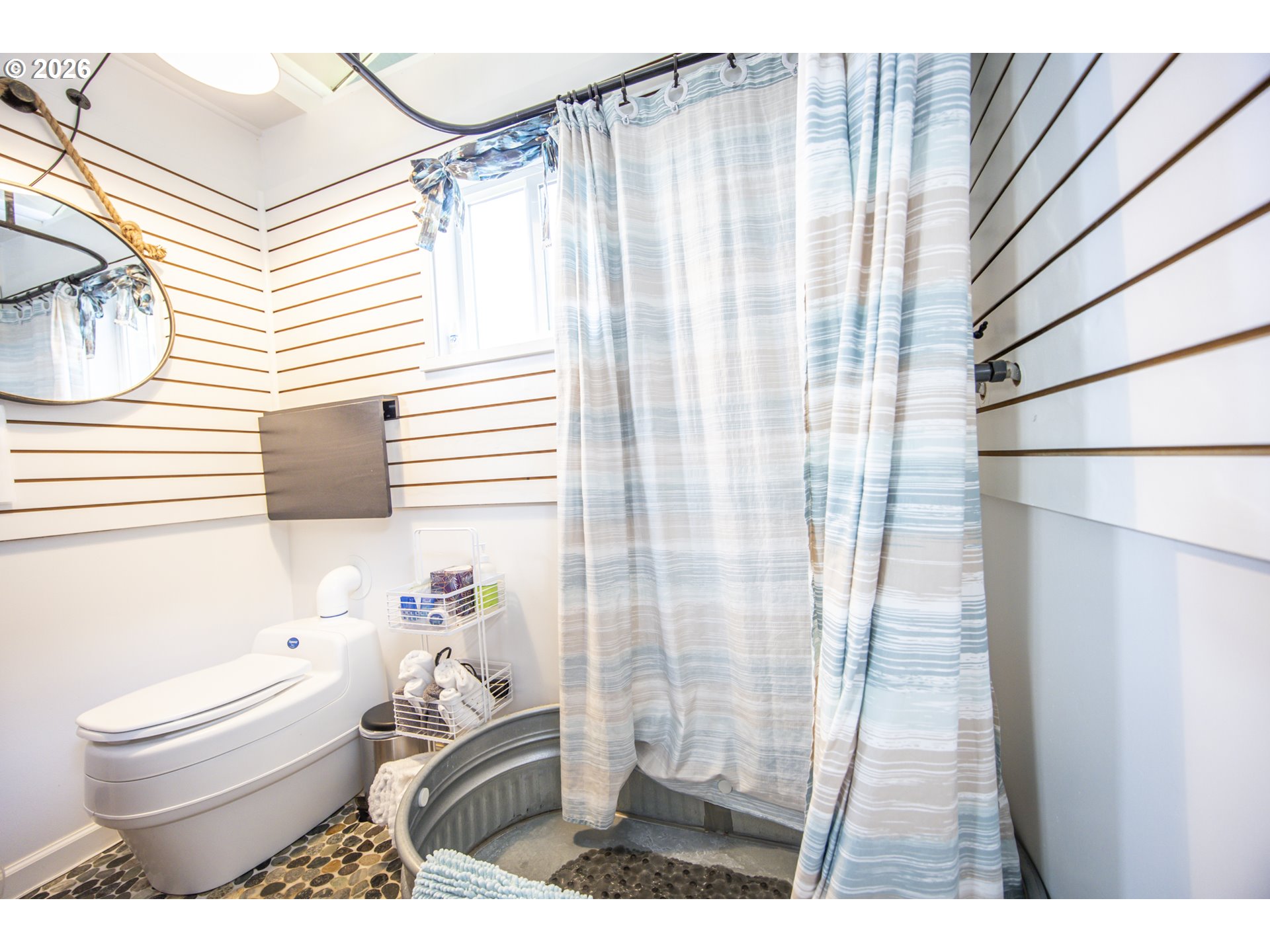 88426 2nd Avenue Florence, OR 97439 - Photo 42 of 45 a bathroom with a toilet and a shower curtain