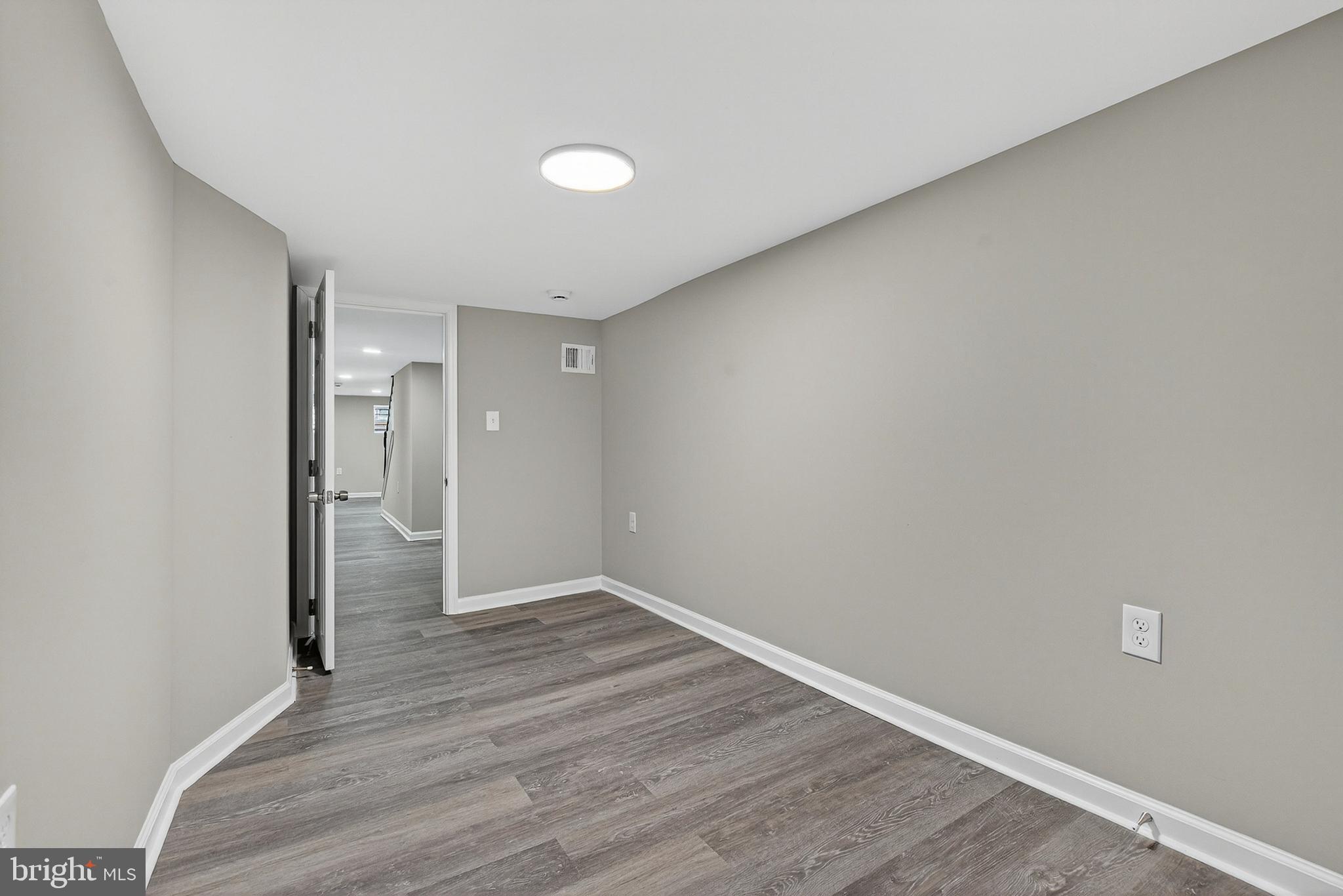 328 South Payson Street Baltimore, MD 21223 - Photo 15 of 27 a view of an empty room and wooden floor