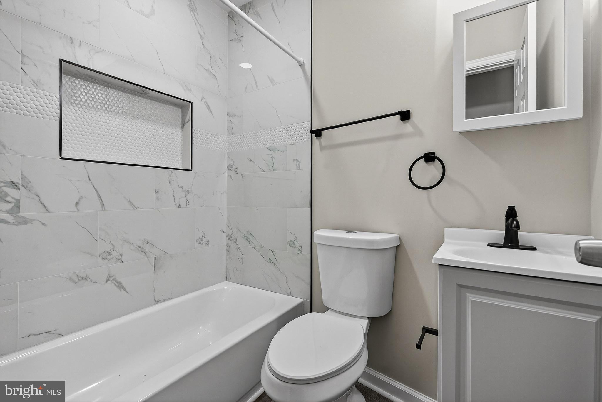328 South Payson Street Baltimore, MD 21223 - Photo 18 of 27 a bathroom with a toilet a sink and mirror