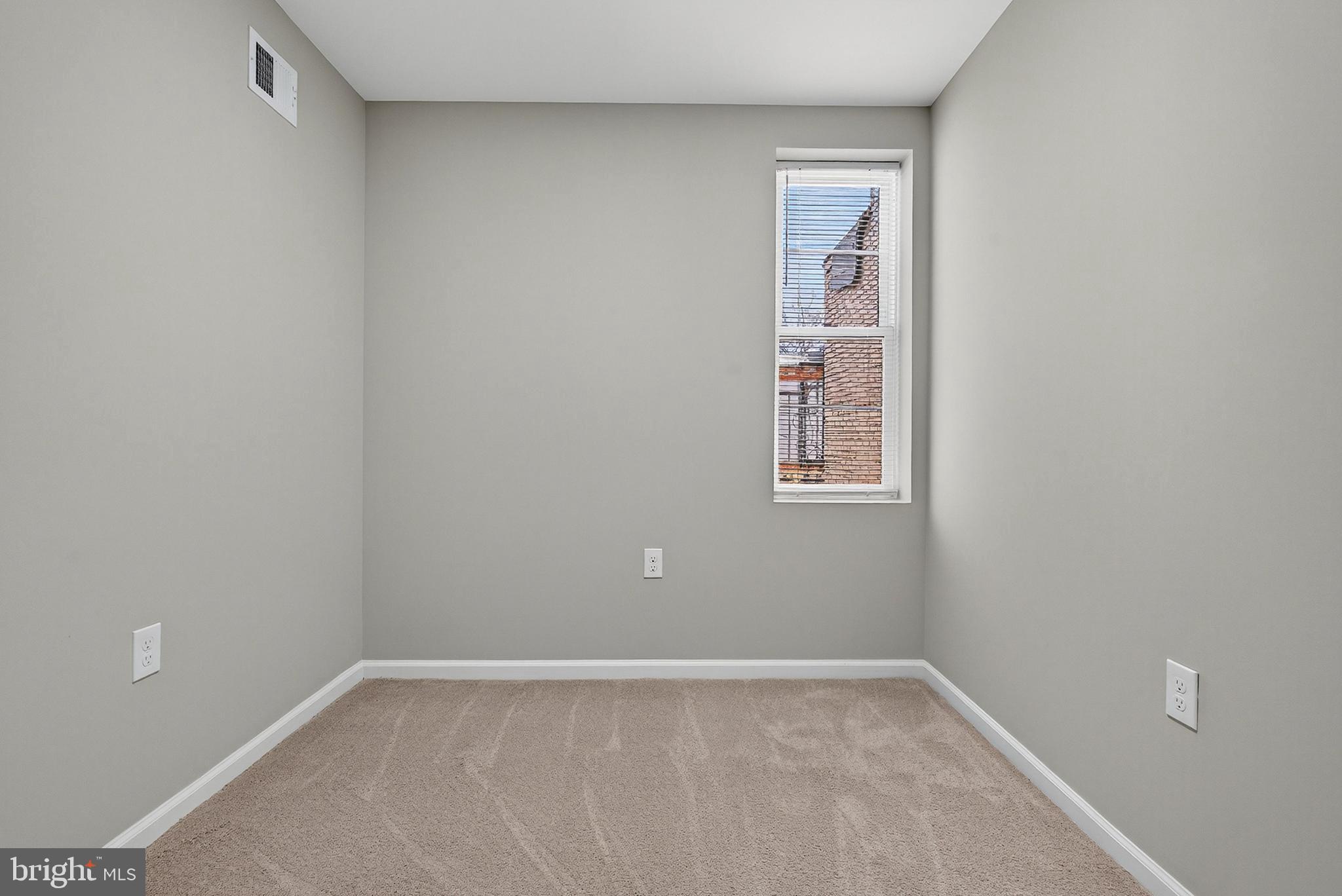 328 South Payson Street Baltimore, MD 21223 - Photo 19 of 27 a view of an empty room with windows