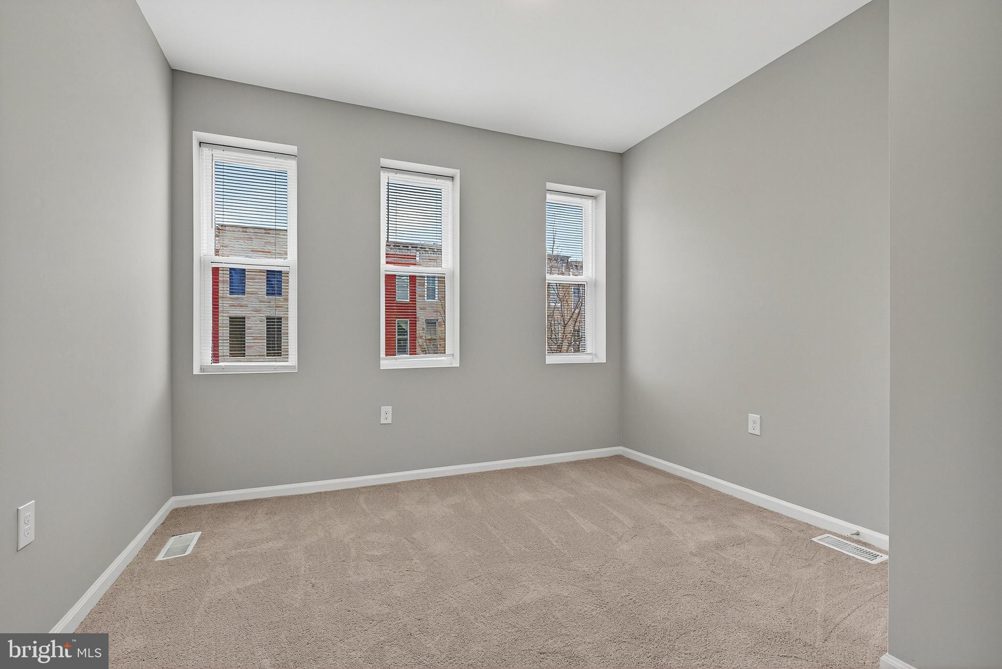328 South Payson Street Baltimore, MD 21223 - Photo 21 of 27 a view of an empty room with windows