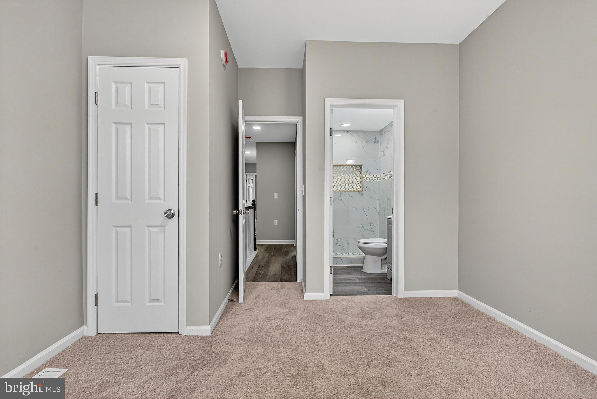 328 South Payson Street Baltimore, MD 21223 - Photo 22 of 27 a view of a bathroom with a walk in closet and wooden floor