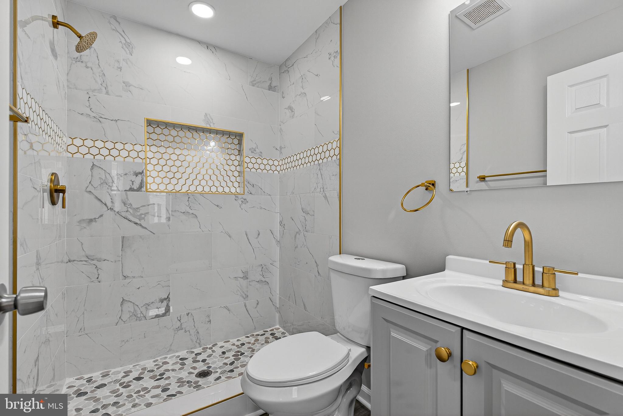 328 South Payson Street Baltimore, MD 21223 - Photo 24 of 27 a bathroom with a sink a toilet and shower