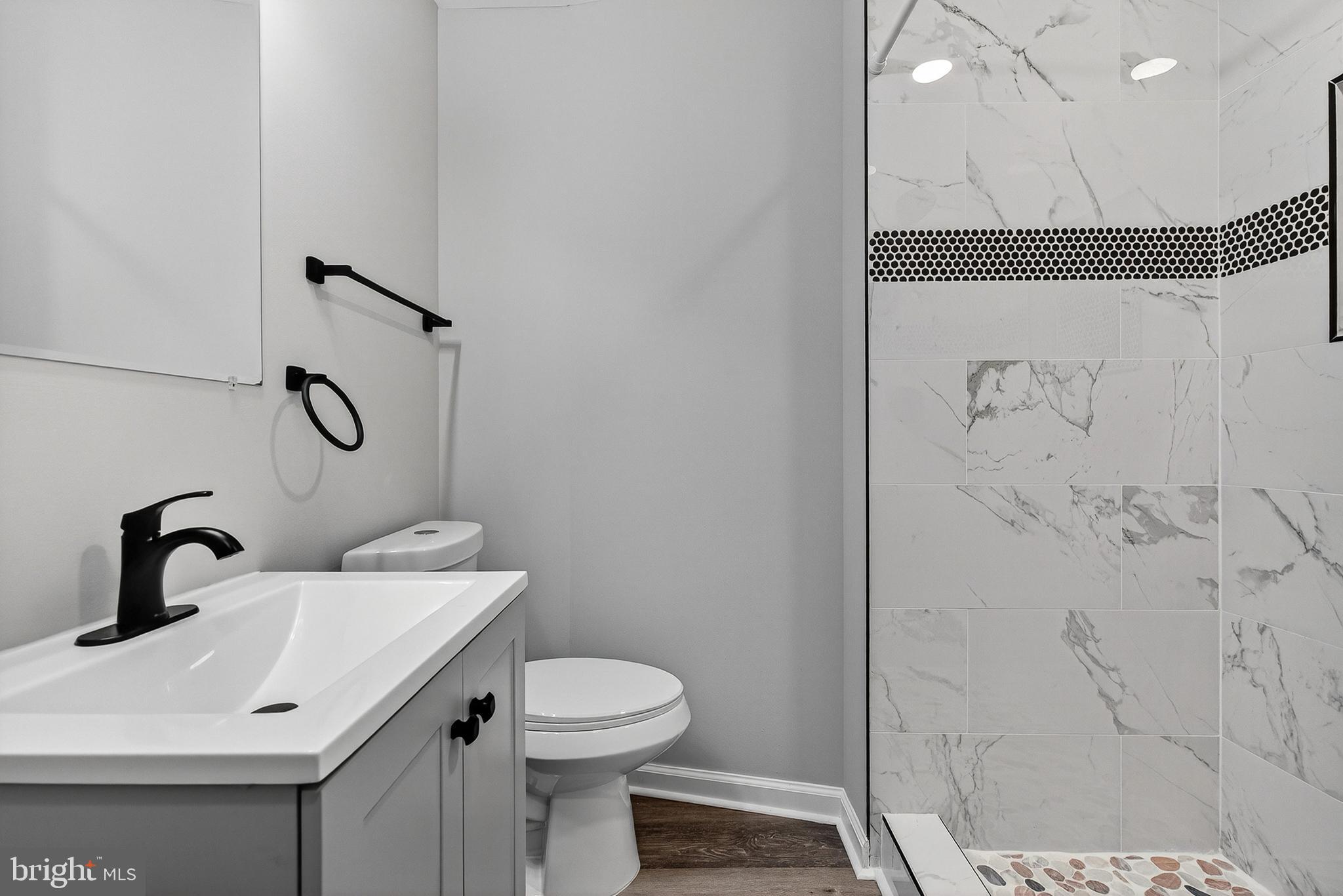 328 South Payson Street Baltimore, MD 21223 - Photo 8 of 27 a bathroom with a sink and mirror