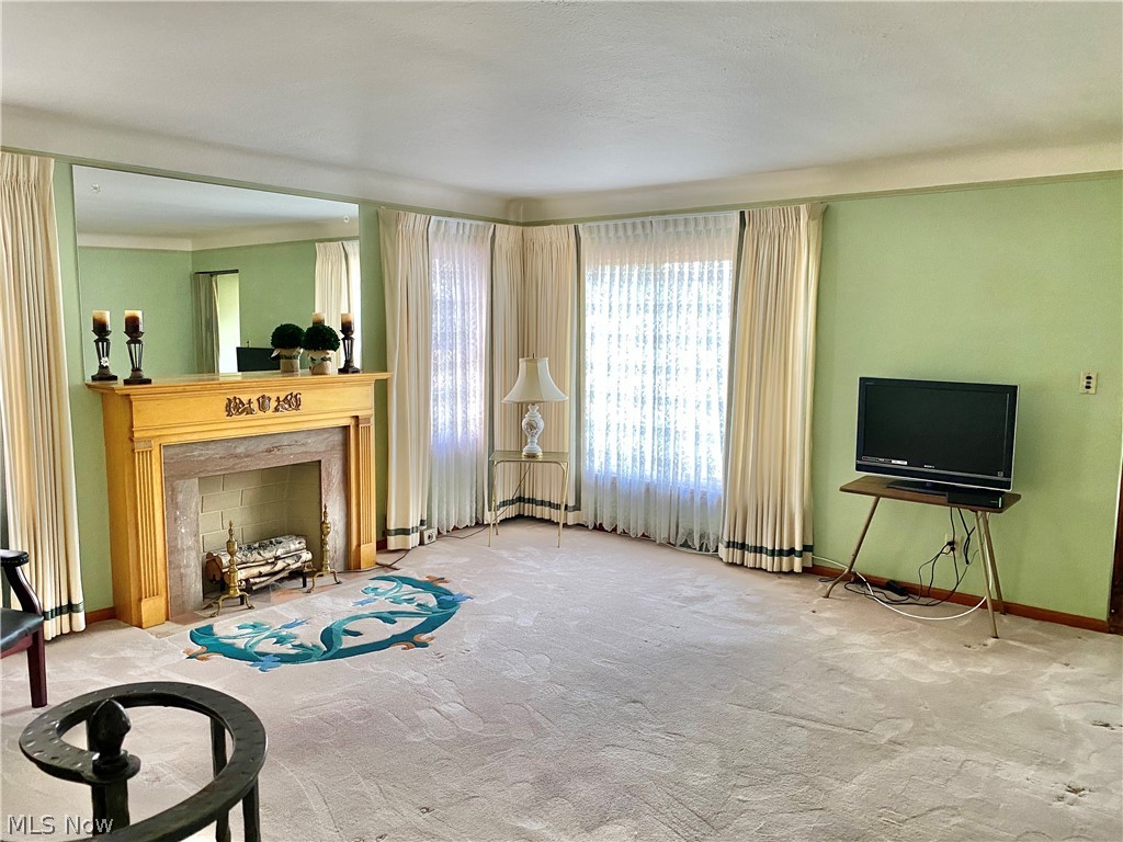 6190 Manchester Road Parma, OH 44129 - Photo 7 of 24 Living Room with hardwood flooring under carpeting and decorative fireplace.