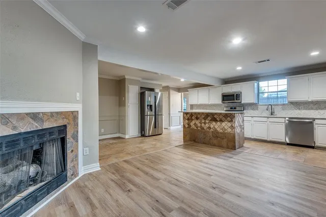 a large kitchen with a stove top oven and refrigerator