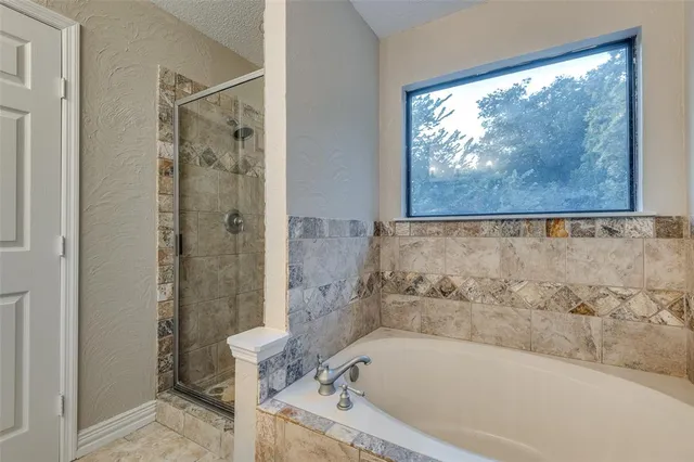 a white bath tub sitting next to a toilet