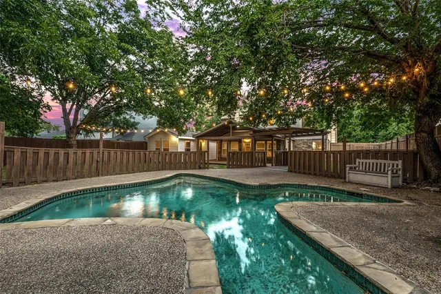 a view of a backyard with wooden fence