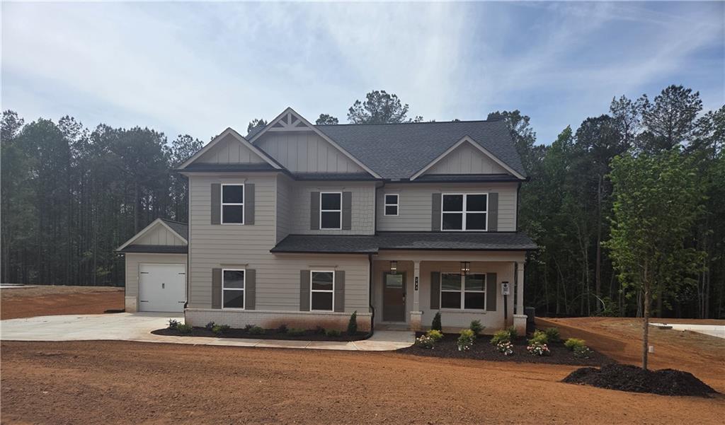 293 Meadows Drive Bethlehem, GA 30620 - Photo 1 of 34 a front view of a house with a yard and garage
