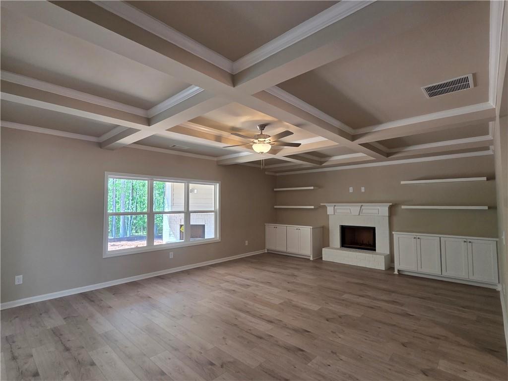 293 Meadows Drive Bethlehem, GA 30620 - Photo 11 of 34 a view of empty room with wooden floor and fireplace
