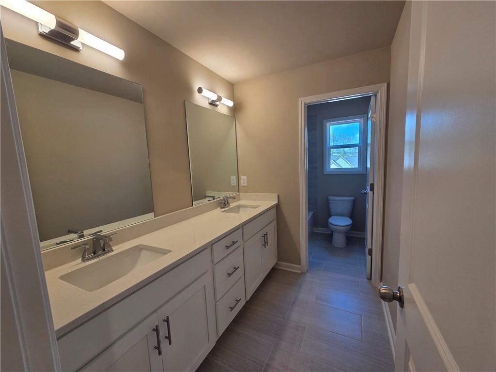293 Meadows Drive Bethlehem, GA 30620 - Photo 26 of 34 a spacious bathroom with a double vanity sink double and mirror