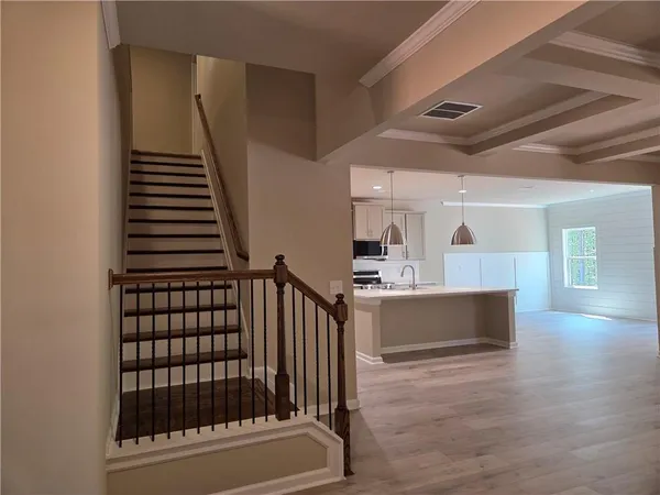 a view of empty room with wooden floor and fireplace