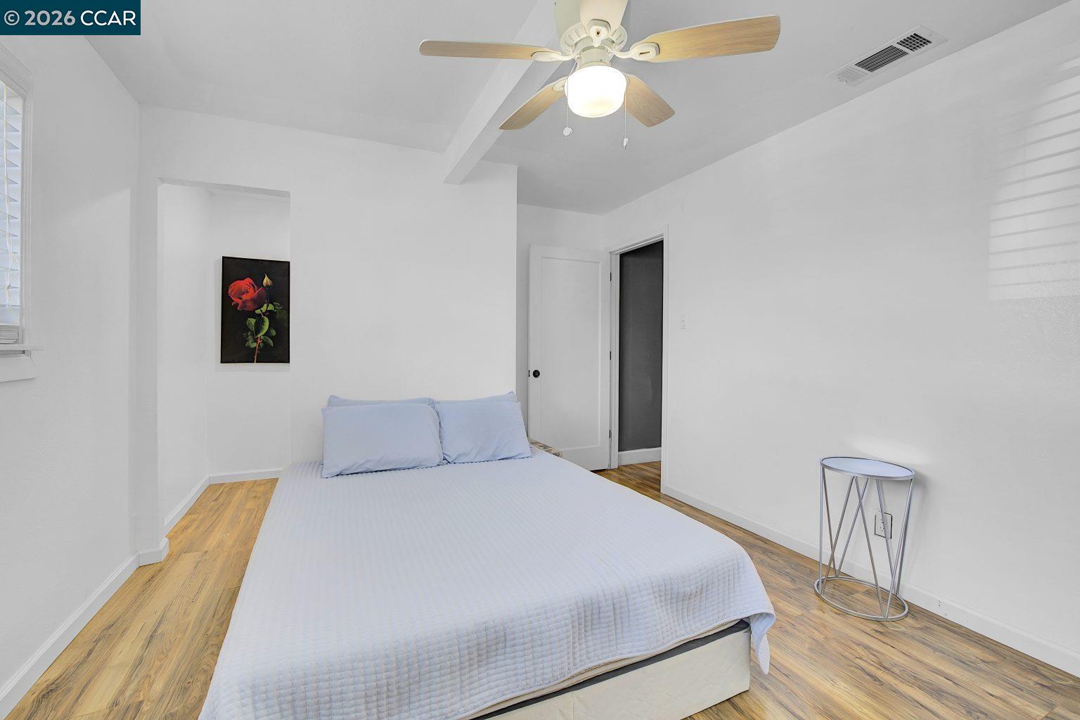 149 Shore Road Bay Point, CA 94565 - Photo 16 of 30 a bedroom with a bed and a chandelier