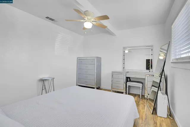 a bedroom with a bed and a table in it