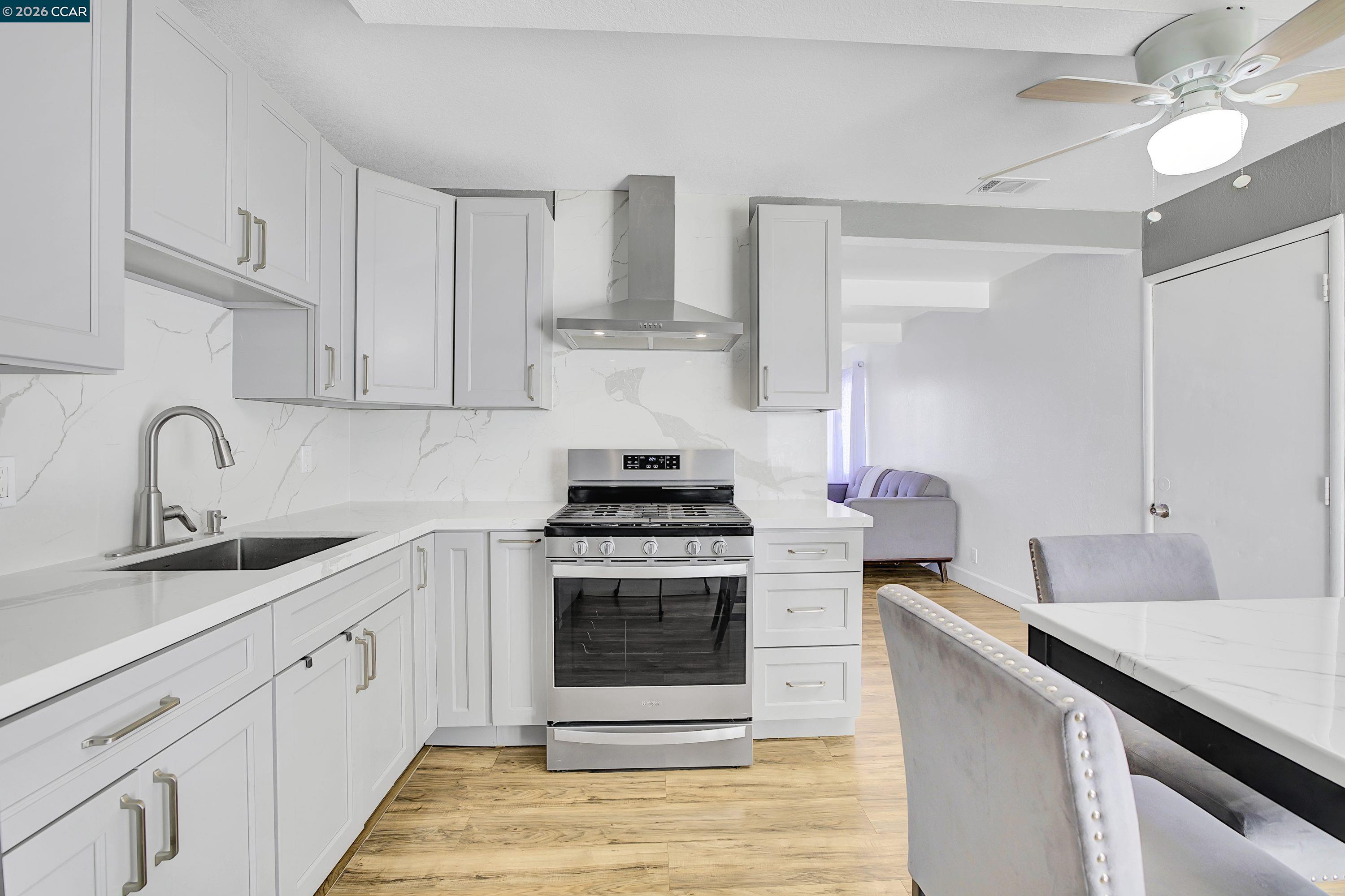 149 Shore Road Bay Point, CA 94565 - Photo 3 of 30 a kitchen with cabinets stainless steel appliances and a sink