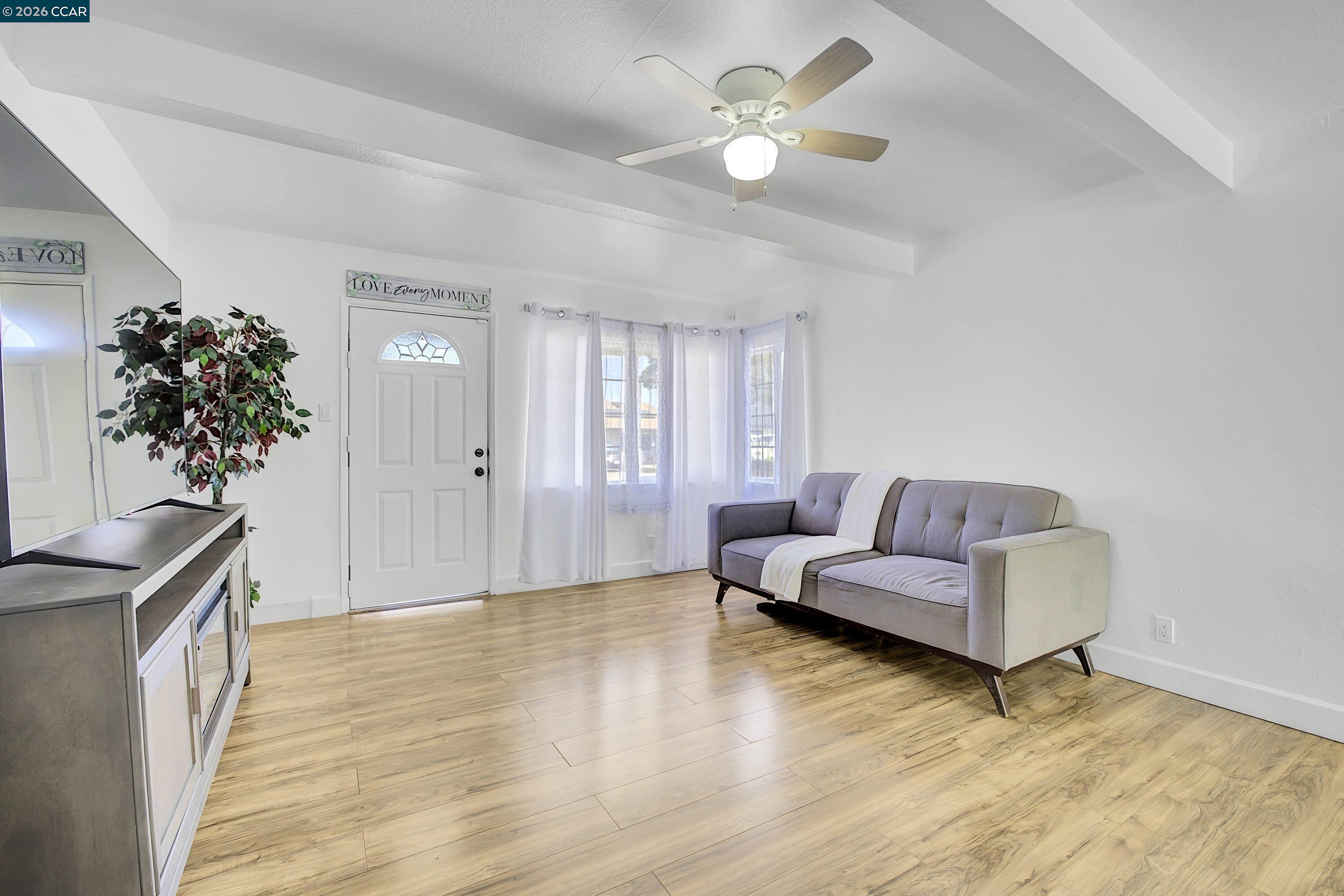 149 Shore Road Bay Point, CA 94565 - Photo 4 of 30 a living room with furniture and a chandelier