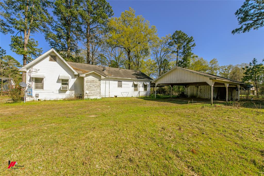 179 Daniel Thomas Road Springhill, LA 71075 - Photo 11 of 37 Back of house featuring a lawn